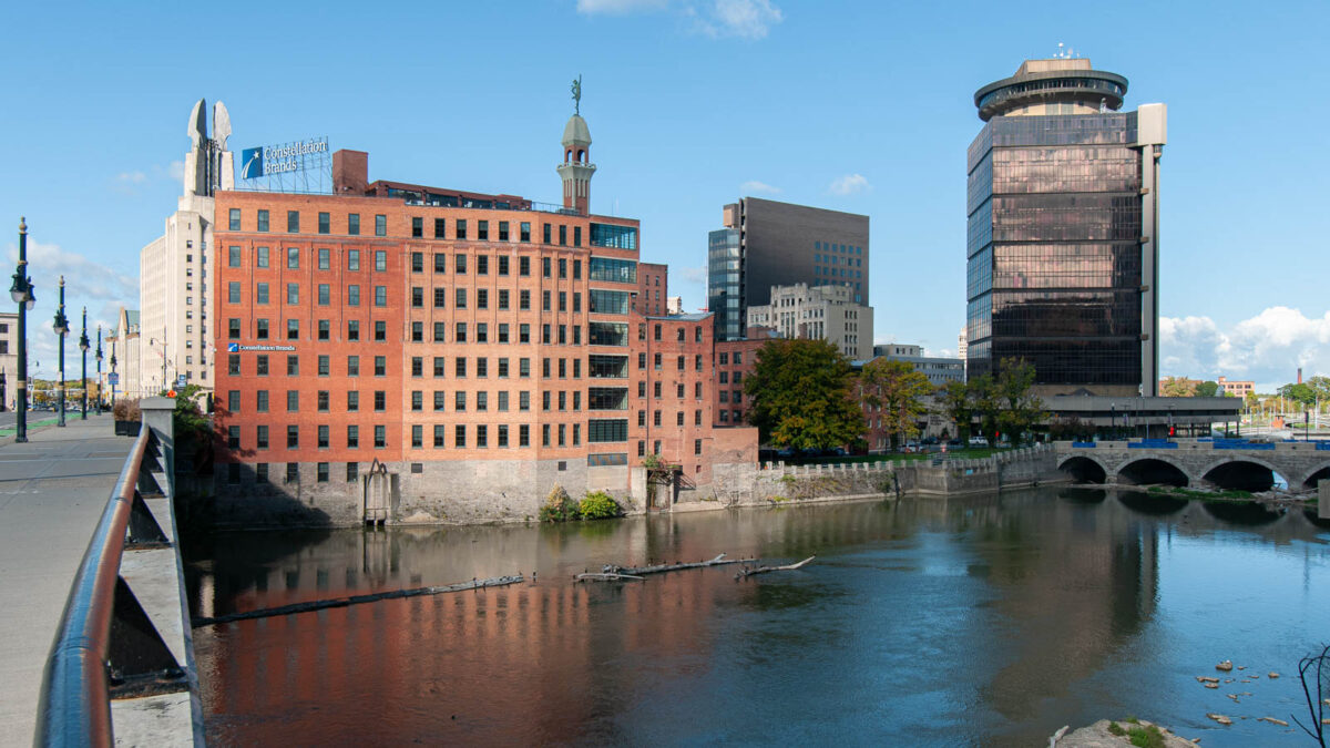 This view of downtown Rochester, New York, looks west across the Genesee River. It was taken from the east end of the Broad Street Bridge, which is built on top of the second Rochester aqueduct, completed in 1842 as part of the first enlargement of the Erie Canal. Mills and other 19th-century industrial buildings, recently renovated to be used as office space, line the opposite bank; Main Street Bridge, finished in 1857, is at the far right. (Steve Boerner)